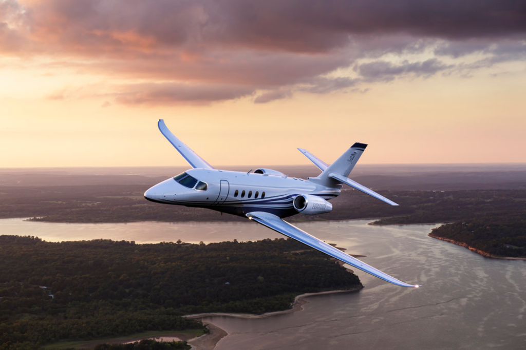 Midsize jet Cessna Citation Latitude Flying over River
