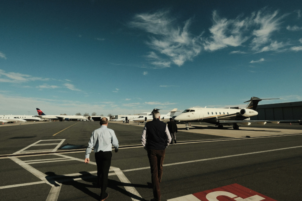 businessmen walking on tarmac to private jet