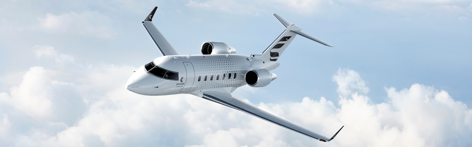 Inflight ultra luxurious jet the Bombardier Challenger 650 flying above clouds