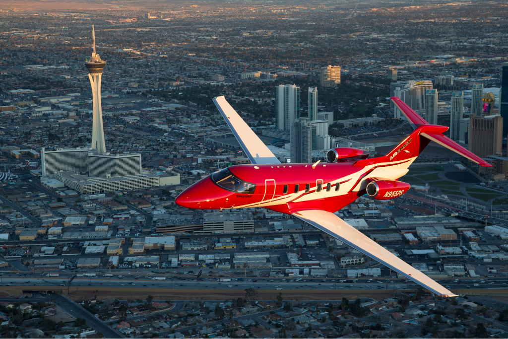 private jet flying over vegas strip in the day