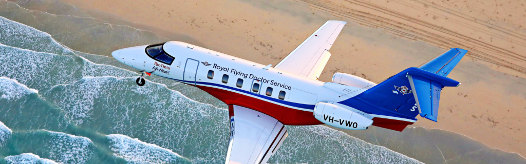 air ambulance royal flying doctor service flying over ocean in australia