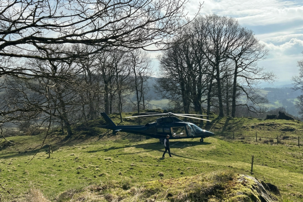 helicopter landing on grass with scenic backdrop