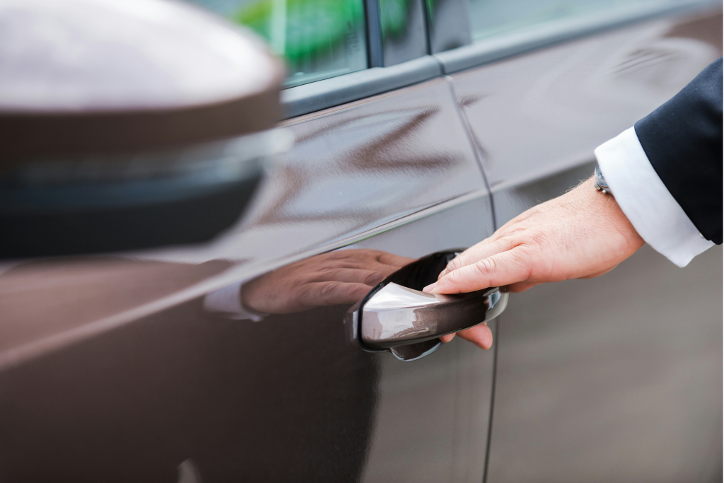 private chauffuer opening luxury car door
