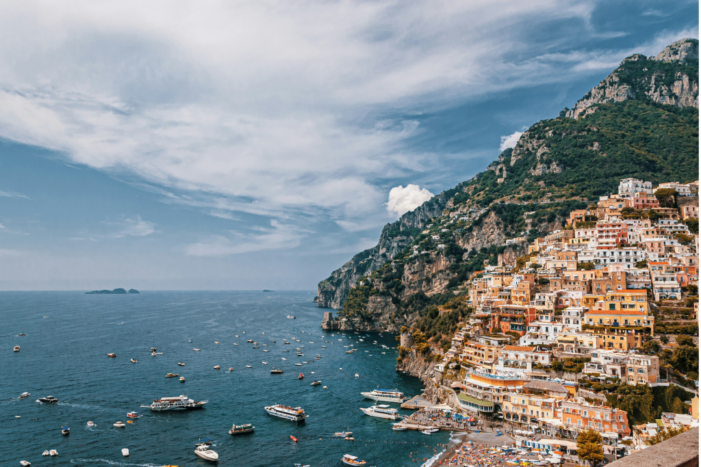 positano on the amalfi coast in italy on a beautiful summers day with luxury yachts in the water