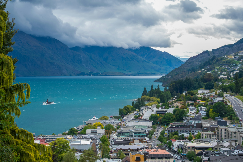 accommodations on the hill in queenstown with rolling hills in the background and Lake Wakatipu
