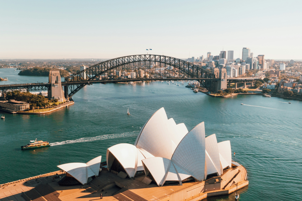 sydney harbour bridge and sydney opera house on the sydney harbour with boats in the water