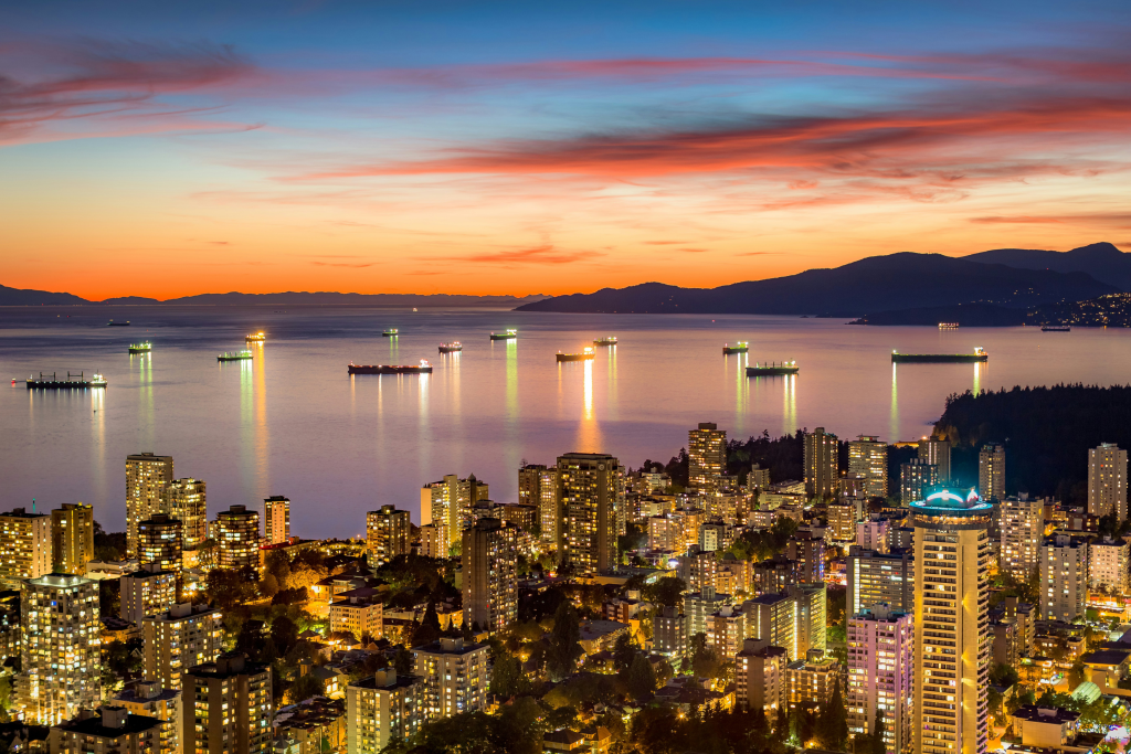 vancouver city skyline with water and boats and mountains in the background