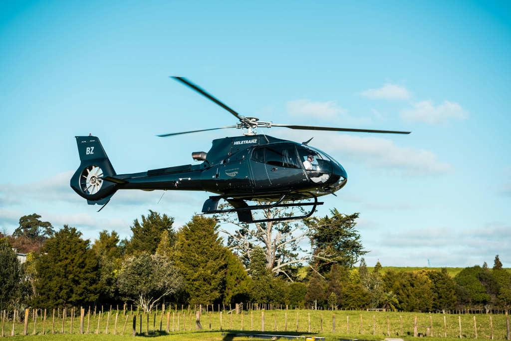 helicopter landing in a vineyard in new zealand