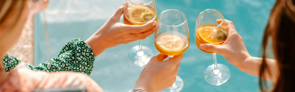 friends 
sharing luxury drinks in a pool